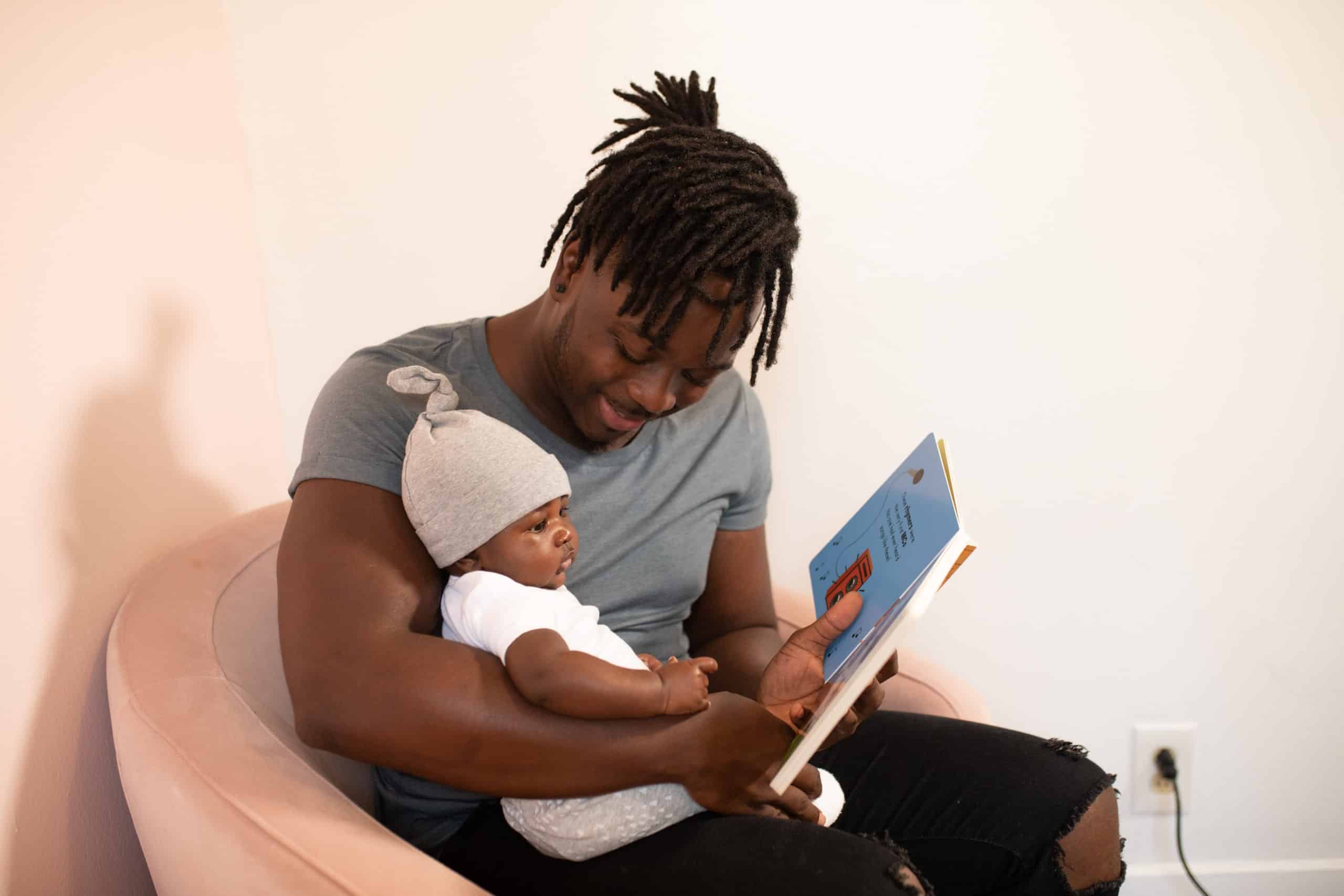 father-reading-to-baby